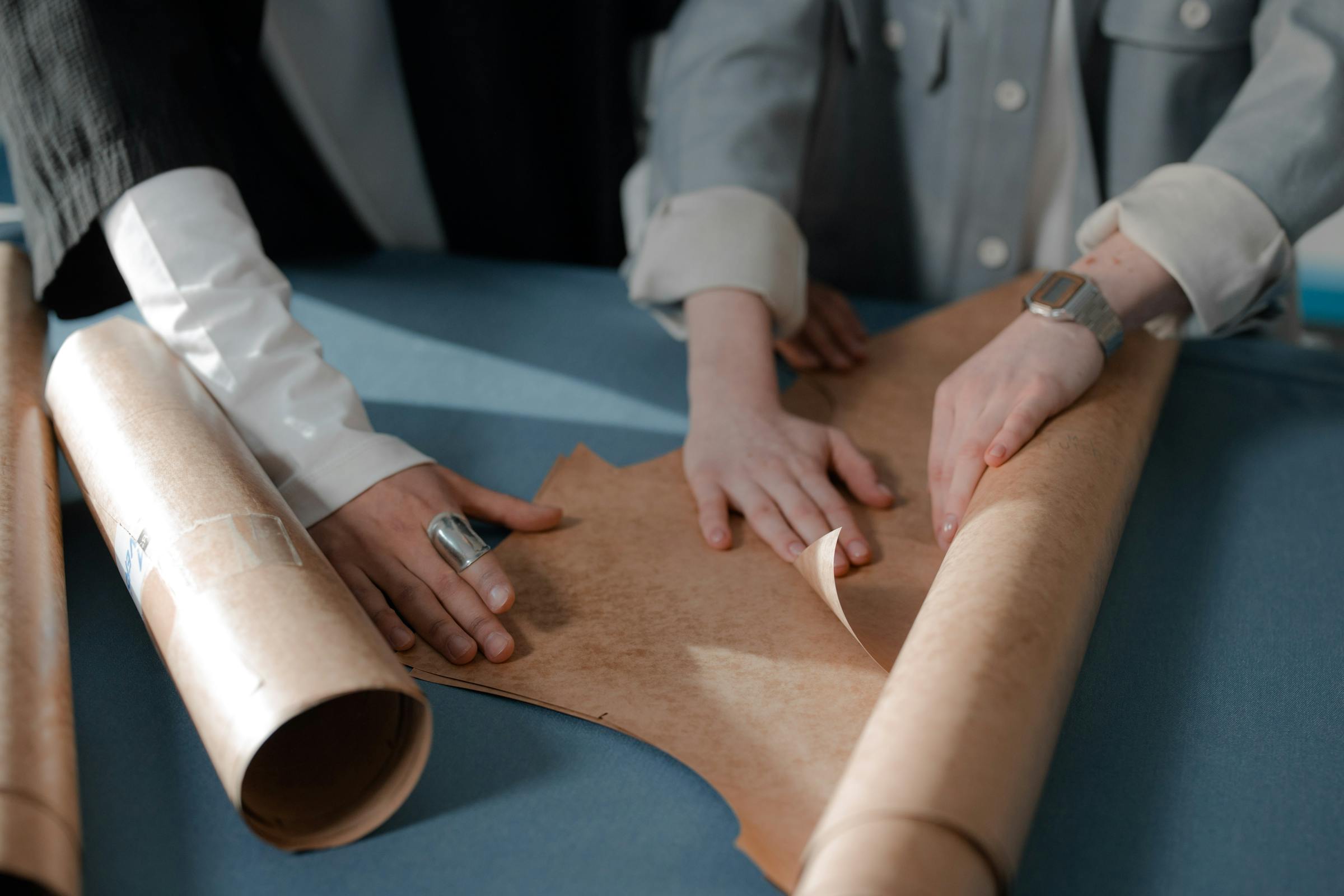 Hands drafting patterns on paper